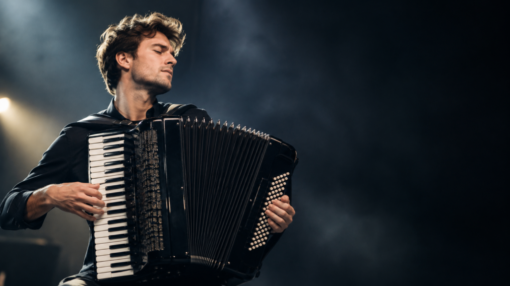 Michael Ziegler playing a black accordion during a dramatic performance.